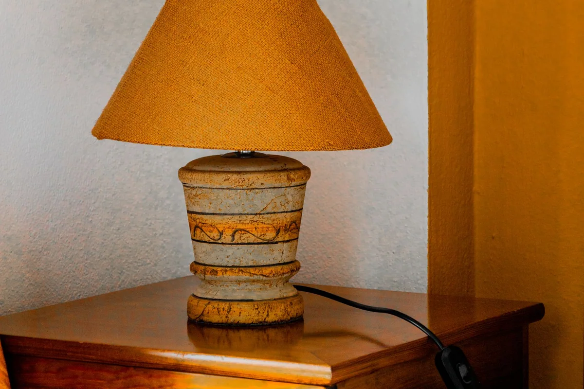 An ottoman lid open to reveal board games and neatly folded textiles