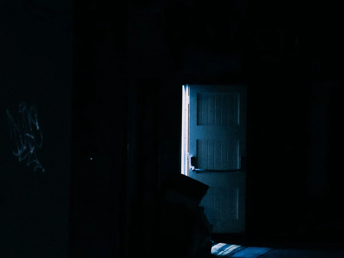 A table lamp brightening a dark corner of a living room